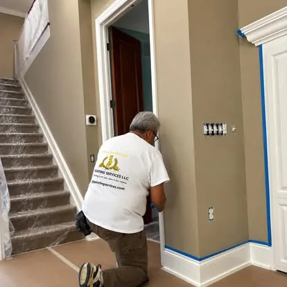Painter cutting in trim around a doorway